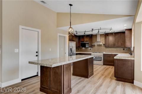 This bright kitchen features water proof plank flooring and granite countertops, perfect for culinary endeavors. This bright kitchen features water proof plank flooring and granite countertops, perfect for culinary endeavors.