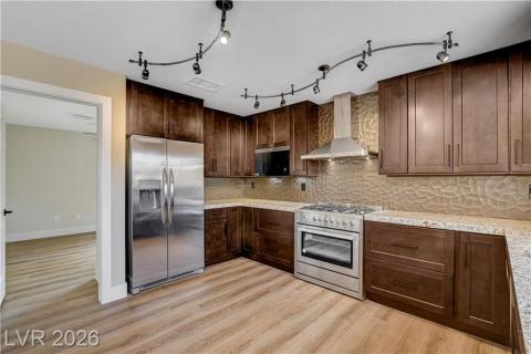 This kitchen features rich cabinetry, granite counters, and modern stainless steel appliances. This kitchen features rich cabinetry, granite counters, and modern stainless steel appliances.