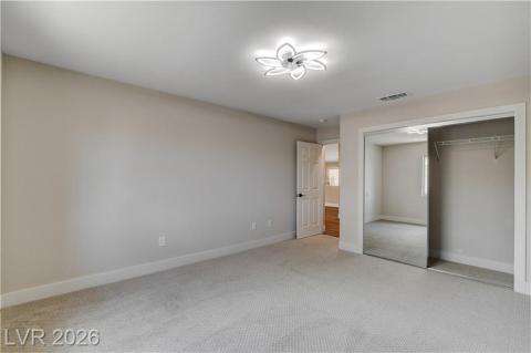 This light-filled bedroom features carpeted flooring and a convenient mirrored closet. This light-filled bedroom features carpeted flooring and a convenient mirrored closet.