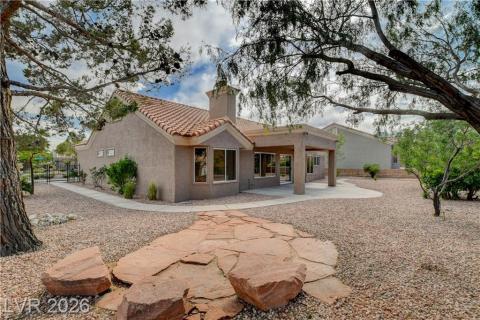 This desert oasis features a covered patio and a charming walkway leading to a private gate. This desert oasis features a covered patio and a charming walkway leading to a private gate.