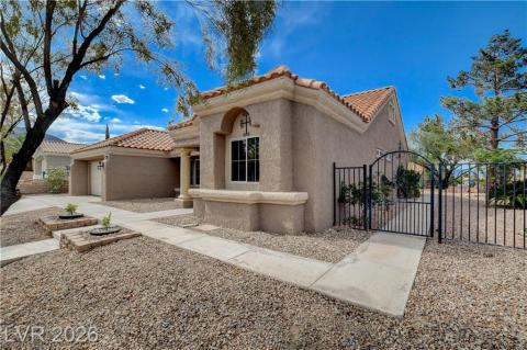 This desert oasis features a classic tiled roof and a charming gated entry. This desert oasis features a classic tiled roof and a charming gated entry.