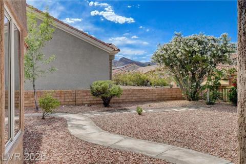 This serene yard features a winding pathway, lush landscaping, and a mountain view. This serene yard features a winding pathway, lush landscaping, and a mountain view.