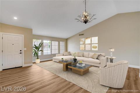 An inviting open-plan living area features vaulted ceilings and ample natural light, creating an airy atmosphere. An inviting open-plan living area features vaulted ceilings and ample natural light, creating an airy atmosphere.