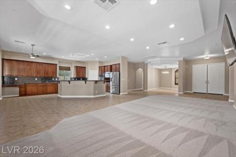 An open-concept living space integrates a well-appointed kitchen with abundant cabinetry and modern appliances.