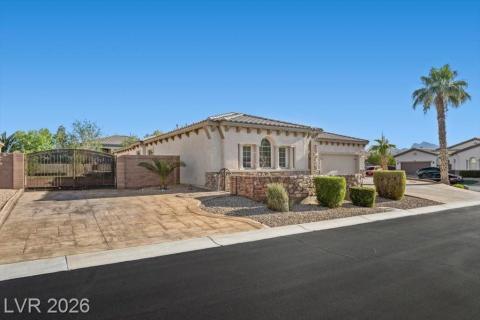A private gate and stone facade welcome you to this desert oasis with an attached garage.