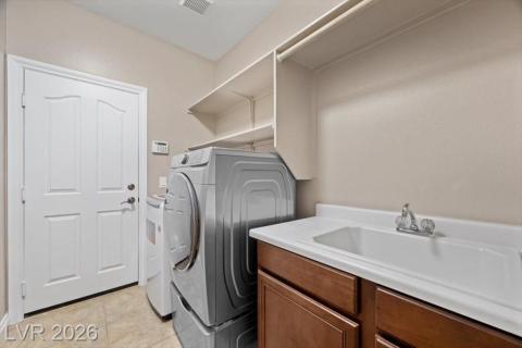 Functional laundry room equipped with a convenient utility sink and efficient appliance stacking.