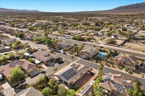 An aerial perspective reveals a well-established neighborhood against a backdrop of distant mountains.