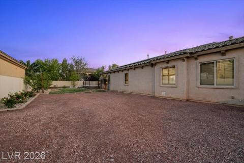 A spacious backyard with a large gravel area offers abundant outdoor potential.