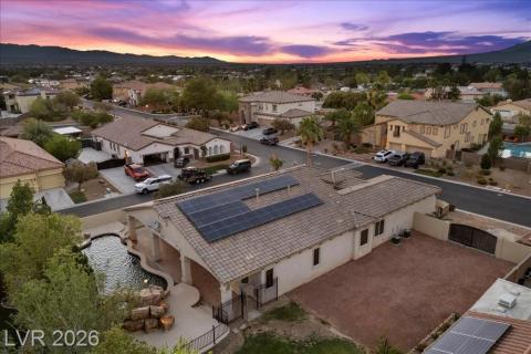 An aerial perspective reveals a beautiful residential area against a stunning sunset backdrop.