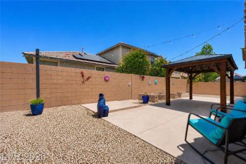 View of the backyard and large patio. View of the backyard and large patio.