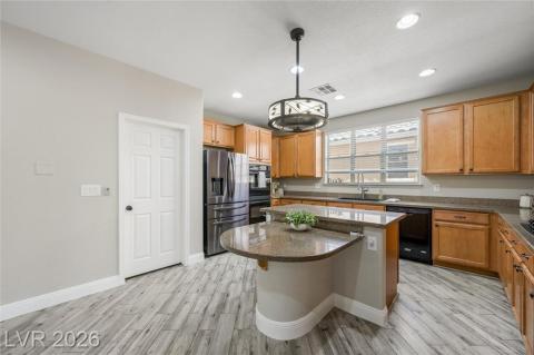 Kitchen with garden window, sleek stainless steel fridge with freezer drawer, and double ovens Kitchen with garden window, sleek stainless steel fridge with freezer drawer, and double ovens