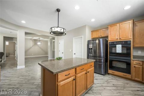 Kitchen with large island, double ovens, and open floorplan to dining room. Kitchen with large island, double ovens, and open floorplan to dining room.