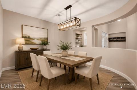 Formal dining room with architectural curved wall and stunning chandelier Formal dining room with architectural curved wall and stunning chandelier