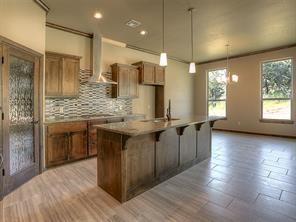 LIVING ROOM WITH WOOD FLOORING AND LOTS OF WINDOWS FOR NATURAL LIGHT