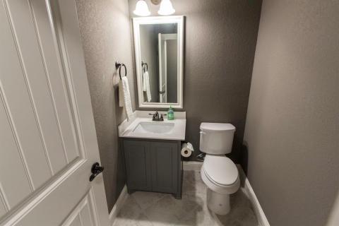 Upstairs half bath for guests playing pool or watching the game upstairs