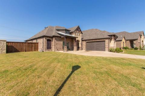 Beautiful stonework and metal accents on roof add to the appeal of the exterior. Covered patio for a bench or chairs.