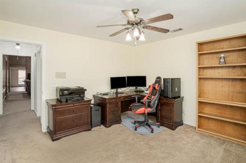 hall bathroom with double sink vanity, built-in linen & storage cabs with laundry hamper