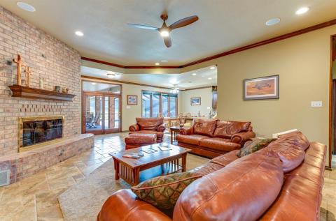 Woodburning fireplace with handsome mantel and circulating blower fan provides supplemental heat.
