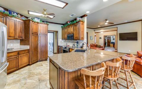Ample cabinets and pantry in kitchen.