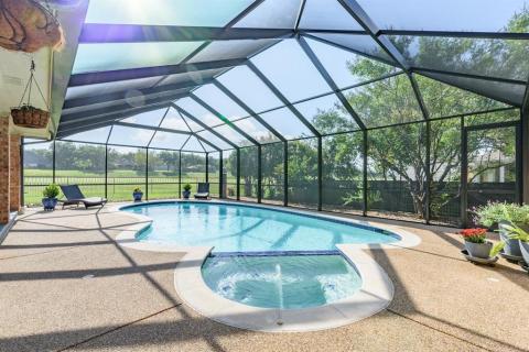 Gorgeous back patio or porch has this incredible pool and gnat-screened enclosure for almost year-round enjoyment. Heated jacuzzi or spa.