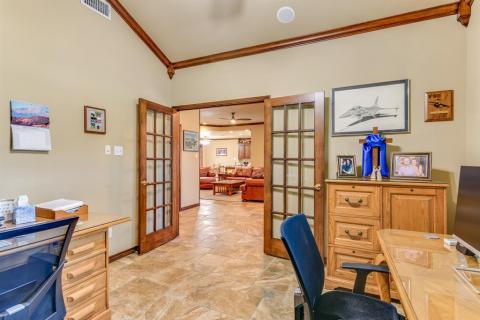 Lovely French doors and natural stained crown molding.