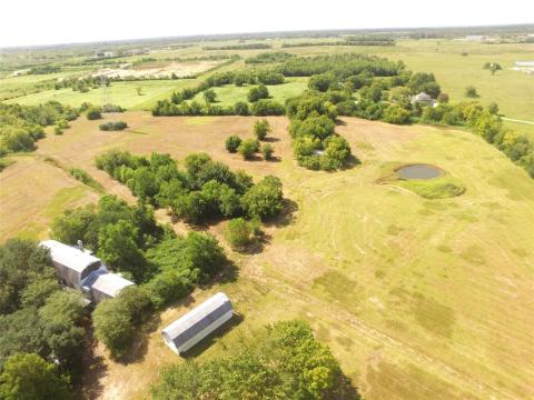 Drone photo of dwelling and metal storage building.